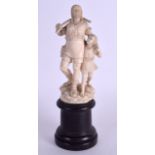 A 19TH CENTURY EUROPEAN CARVED IVORY FIGURE OF A STANDING MALE modelled holding his son upon a rocky