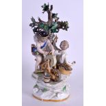 A 19TH CENTURY MEISSEN PORCELAIN FIGURAL GROUP modelled as two putti standing beside a tree. 20 cm x