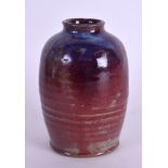 A STUDIO POTTERY FLAMBÉ POTTERY VASE of ribbed decoration. 11 cm high.