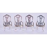 A SET OF FOUR SOLID SILVER MINIATURE CHAIRS. 3.2 cm high.