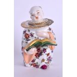 A 19TH CENTURY CONTINENTAL PORCELAIN FIGURAL INKWELL AND COVER modelled as a seated male in