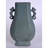 A CHINESE PALE BLUE GLAZED VASE, formed with twin handles.23 cm high.