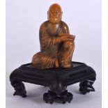 A CHINESE CARVED SHOU SHAN STONE STATUE OF A SCHOLAR, seated holding a scroll. Figure 7.5 cm.