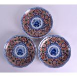 A SET OF THREE 19TH CENTURY JAPANESE MEIJI PERIOD IMARI PLATES painted with a central Buddhistic