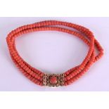 AN 18CT GOLD AND RED CORAL NECKLACE with coral open work clasp. 88 grams. 36 cm long.