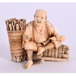 A SMALL 19TH CENTURY JAPANESE MEIJI PERIOD CARVED IVORY OKIMONO modelled as a seated male beside