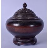 A CHINESE BRONZE CENSER AND STAND, globular in shape with reticulated cover. 13 cm wide and weight