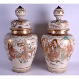 A VERY LARGE PAIR OF 19TH CENTURY JAPANESE MEIJI PERIOD SATSUMA VASES AND COVERS painted with