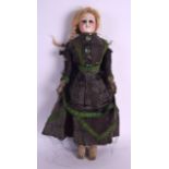 A 19TH CENTURY FRENCH PORCELAIN HEADED DOLL possibly by Bebe Jumeau, modelled in period green and
