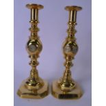 A PAIR OF BRASS CANDLESTICKS, the bases stamped "Good Luck" with horse shoe impression. 32 cm.