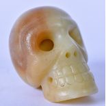 A CARVED HARDSTONE ORNAMENT, in the form of a skull. 6.5 cm high.