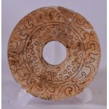 A CHINESE CARVED HARDSTONE BI DISC, decorated with stylised foliage. 11 cm wide.