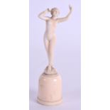 A MINIATURE 19TH CENTURY FRENCH CARVED IVORY FIGURE OF A NUDE DANCER modelled upon an oval base. 9