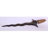 AN 18TH/19TH CENTURY SRI LANKAN CARVED IVORY AND STEEL KRISS DAGGER with seaweed affect to blade. 47