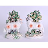 A GOOD PAIR OF 18TH CENTURY DERBY FIGURES OF SHEEP modelled upon rococo scrolling bases. 7 cm wide.