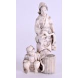 A 19TH CENTURY JAPANESE MEIJI PERIOD CARVED IVORY OKIMONO modelled as a male and female beside a