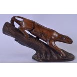 A LARGE CARVED WOODEN FIGURAL GROUP, in the form of a panther climbing down a tree trunk. 35 cm