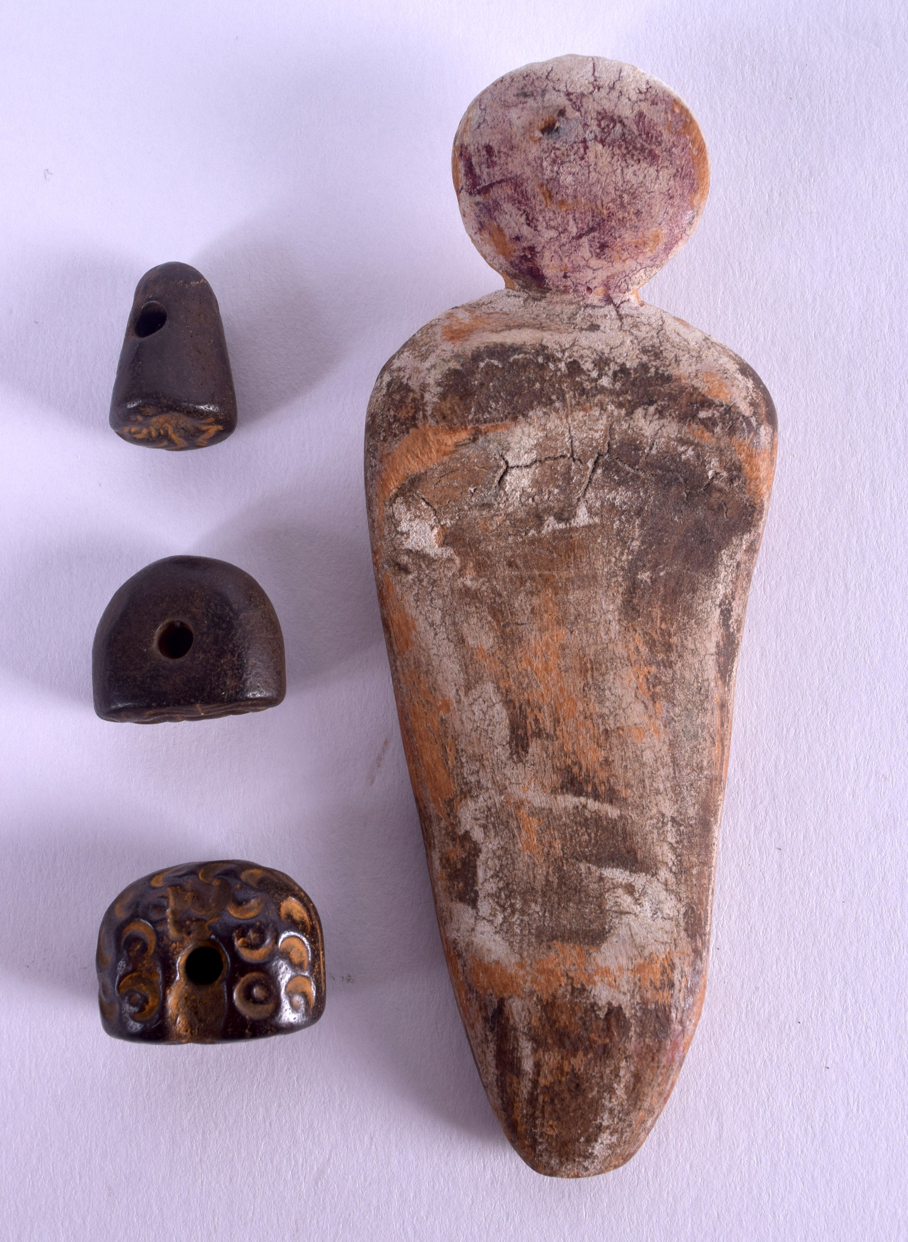 A UNUSUAL EGYPTIAN CARVED AND PAINTED WOODEN AMULET together with three Central Asian seals. (4)