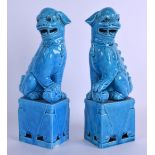 A PAIR OF EARLY 20TH CENTURY CHINESE TURQUOISE GLAZED DOGS OF FOE modelled upon open work bases.