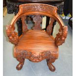 AN UNUSUAL EARLY 20TH CENTURY CHINESE CARVED HARDWOOD ARM CHAIR with kylin mask head handles and