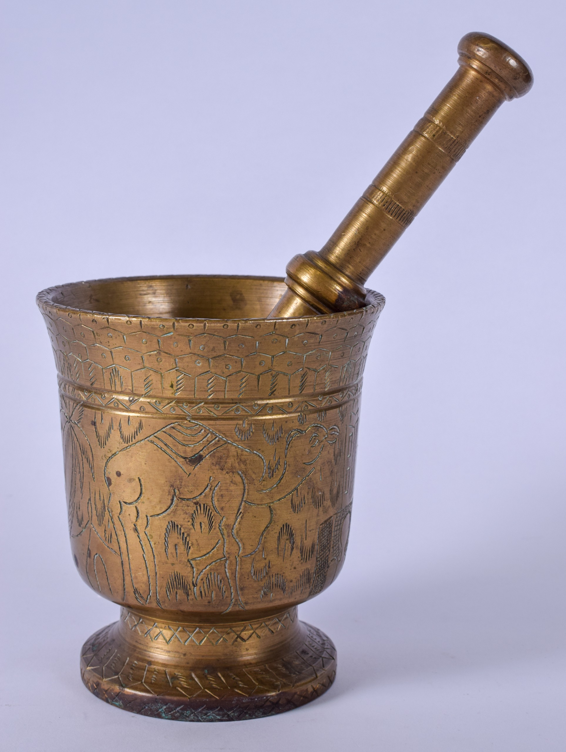 AN EARLY 20TH CENTURY HEAVY BRONZE PESTLE AND MORTAR, engraved with Eastern scenes depicting a camel