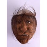 A VERY UNUSUAL TRIBAL CARVED COCONUT HEAD. 23 cm x 17 cm.