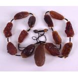 AN UNUSUAL CENTRAL ASIAN CARVED STONE NECKLACE. 94 cm long overall.