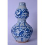 A 20TH CENTURY CHINESE BLUE AND WHITE DOUBLE GOURD SHAPED PORCELAIN VASE, decorated with foliage. 36