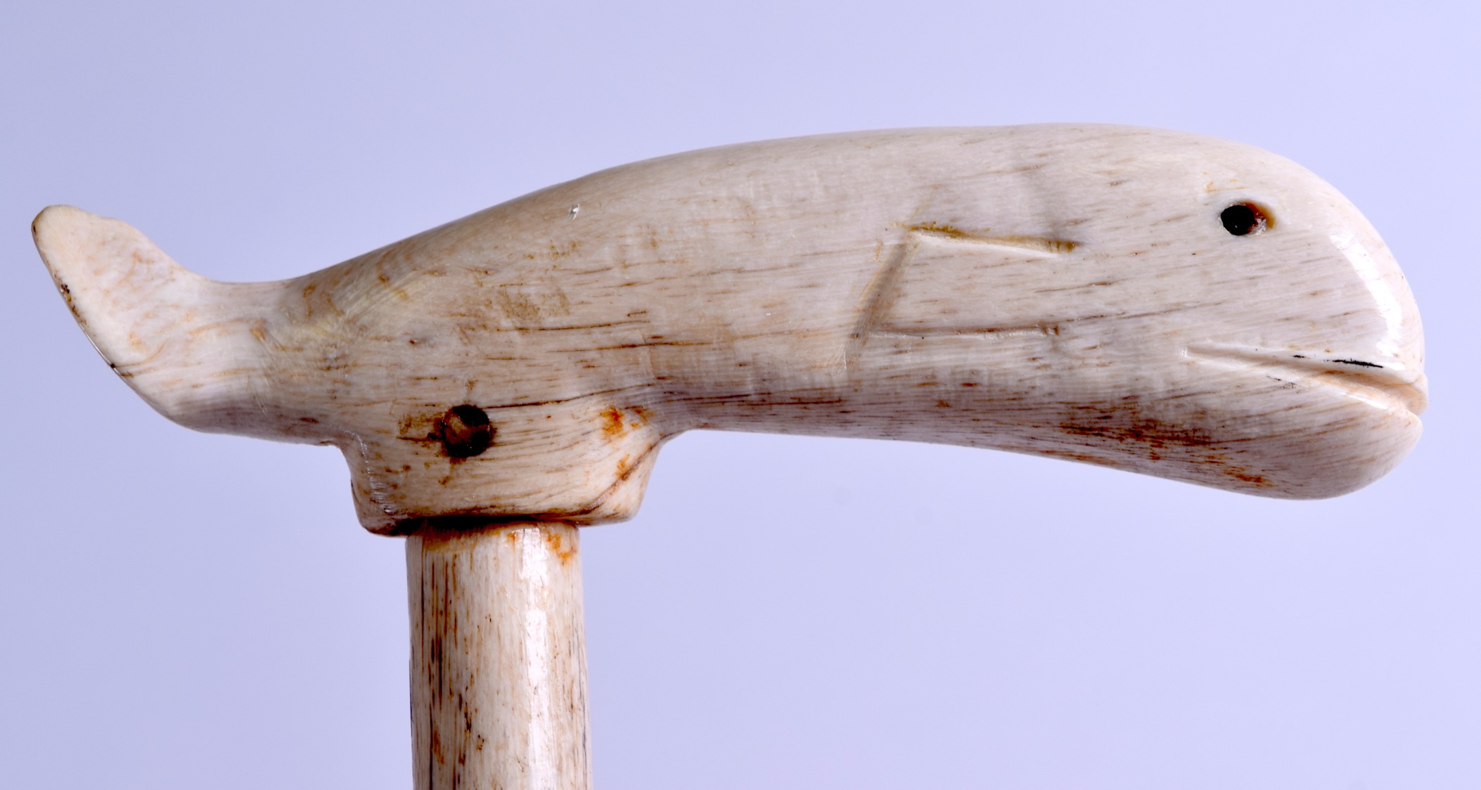 A RARE 19TH CENTURY CARVED WHALE BONE WALKING CANE with naively carved terminal. 93 cm x 12 cm.