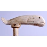 A RARE 19TH CENTURY CARVED WHALE BONE WALKING CANE with naively carved terminal. 93 cm x 12 cm.