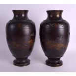 A GOOD PAIR OF 19TH CENTURY JAPANESE MEIJI PERIOD BRONZE VASES decorated with birds in flight over