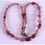 AN EARLY CONTINENTAL CARVED PINK STONE NECKLACE. 38 cm long overall.