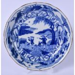 AN EARLY 20TH CENTURY JAPANESE BLUE AND WHITE PORCELAIN DISH, unusually decorated with European