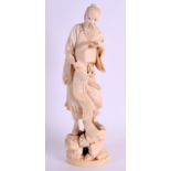 A 19TH CENTURY JAPANESE MEIJI PERIOD CARVED IVORY OKIMONO modelled as a male holding an open scroll.