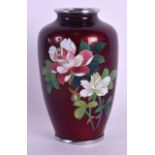 AN EARLY 20TH CENTURY JAPANESE MEIJI PERIOD CLOISONNE ENAMEL VASE decorated with flowers on a red