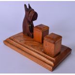 AN EARLY 20TH CENTURY CARVED OAK INKWELL, decorated with a carved scottie dog. 13.5 cm x 19.5 cm.