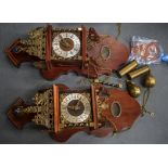 A PAIR OF 20TH CENTURY WALL CLOCKS, decorated with metal mounts depicting figures in various