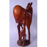 A HUGE AFRICAN CARVED HARDWOOD SCULPTURE OF A DEER, modelled standing feeding her young. 53 cm