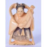 AN EARLY 20TH CENTURY JAPANESE STAINED NETSUKE IN THE FORM OF A FEMALE MUSICIAN, modelled standing