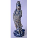A LARGE CHINESE BLUE AND WHITE POTTERY STATUE OF GUANYIN, modelled standing with arms inside robes