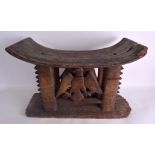 AN EARLY 20TH CENTURY AFRICAN TRIBAL ASANTE WOODEN STOOL formed with a bird between ridged supports.
