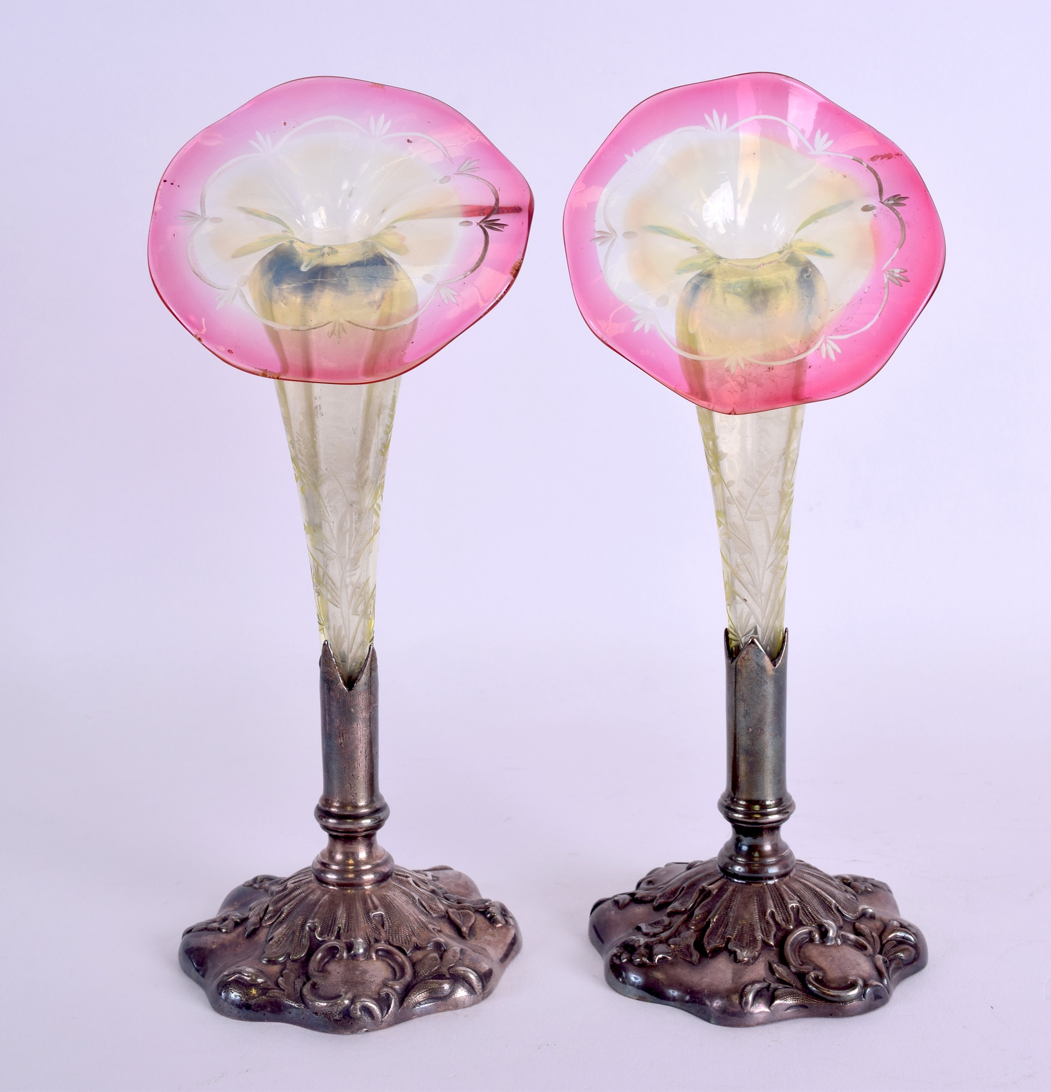 A LOVELY PAIR OF LATE VICTORIAN GLASS POSY VASES in the manner of Webb, set within embossed silver