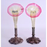 A LOVELY PAIR OF LATE VICTORIAN GLASS POSY VASES in the manner of Webb, set within embossed silver