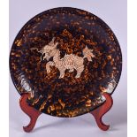 A LARGE CHINESE HARES FOOT TYPE POTTERY PLATE, decorated with a mythical beast. 34 cm wide.