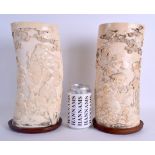 A LARGE PAIR OF 19TH CENTURY JAPANESE MEIJI PERIOD CARVED IVORY TUSK VASES decorated with figures