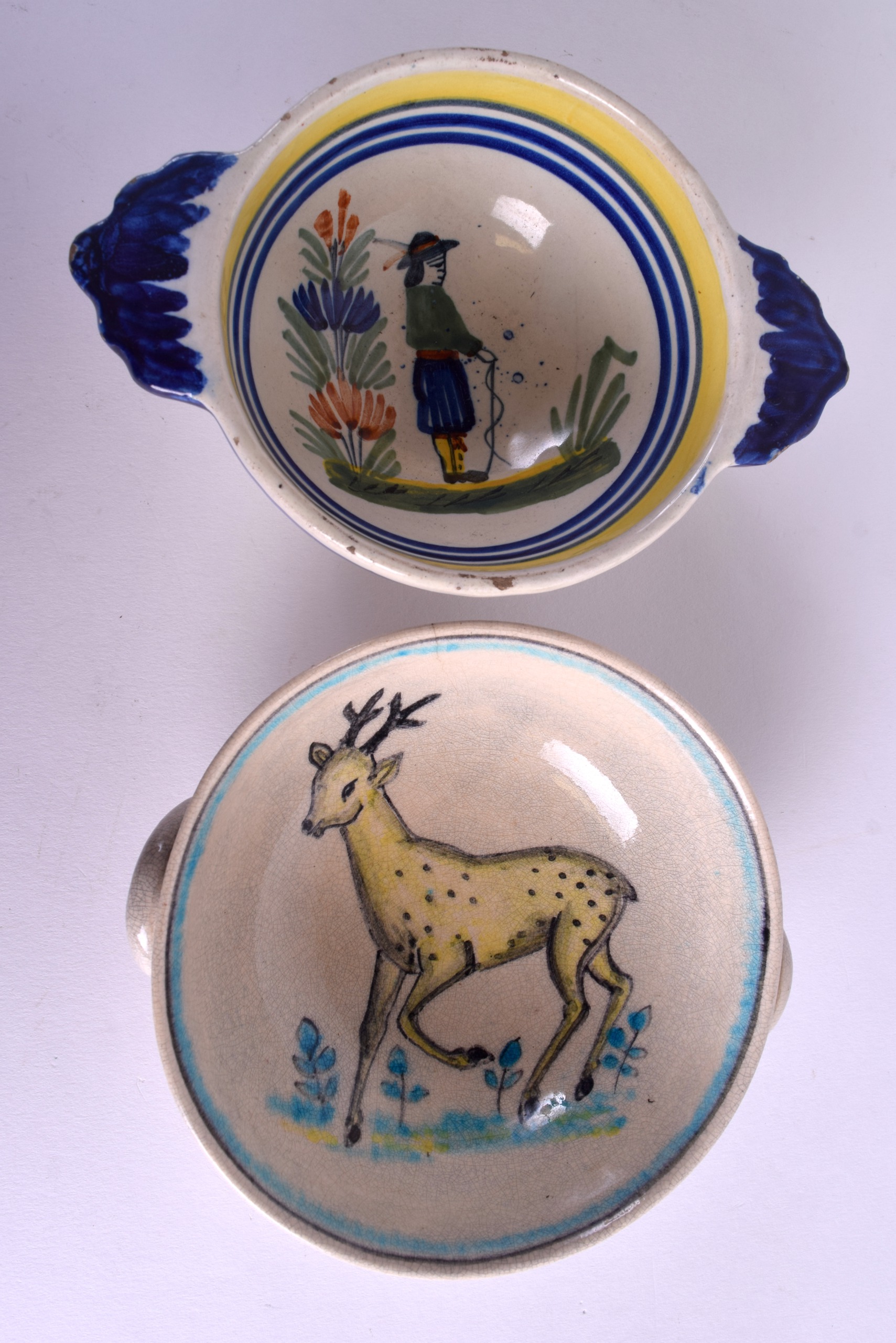 TWO EARLY 20TH CENTURY FRENCH FAIENCE QUAICHES one bearing Quimper signature. 14 cm & 12 cm wide. (