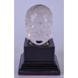 A CARVED ROCK CRYSTAL BUDDHA HEAD, modelled upon a fitted wooden plinth. Total height 11 cm.