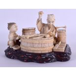 A 19TH CENTURY JAPANESE MEIJI PERIOD CARVED IVORY OKIMONO upon a fitted wooden base, modelled as a