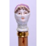 AN UNUSUAL 19TH CENTURY CONTINENTAL PORCELAIN 'MASKED FEMALE' PARASOL unusually formed as a gypsy