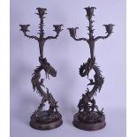 AN UNUSUAL PAIR OF 19TH CENTURY JAPANESE MEIJI PERIOD BRONZE TRIPLE CANDLEABRA formed as dragons
